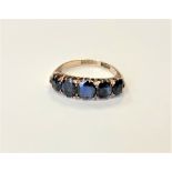 A 9ct gold five stone synthetic sapphire ring, size N CONDITION REPORT: 3.