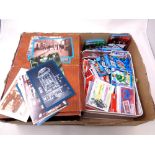 A box containing a large quantity of contemporary postcards,