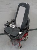 An electric wheelchair with charger together with a Homedics massage cushion