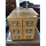 An early 20th century oak six drawer index chest