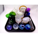 A tray containing silver lidded glass scent bottle, glass paperweights including Caithness,