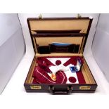 A leather briefcase containing Masonic regalia including sash,