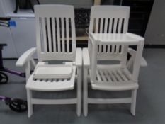 A pair of Hartman white plastic folding reclining armchairs,