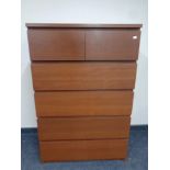 A teak effect six drawer chest