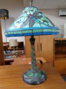 A contemporary Tiffany style table lamp decorated with dragonflies