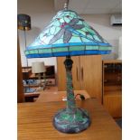 A contemporary Tiffany style table lamp decorated with dragonflies