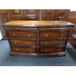 A mahogany effect bow fronted chest of six drawers