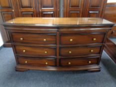 A mahogany effect bow fronted chest of six drawers