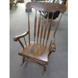 A beech spindle back rocking chair