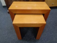 A nest of two contemporary satin wood tables