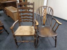 An oak ladder back rush seated chair together with a wheel back chair