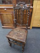 An Edwardian carved oak barley twist hall chair