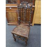 An Edwardian carved oak barley twist hall chair