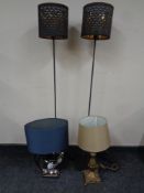 A pair of contemporary metal floor lamps with shades together with two further table lamps with