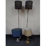 A pair of contemporary metal floor lamps with shades together with two further table lamps with