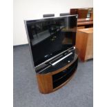 A Panasonic 47" LCD TV on contemporary oval television stand