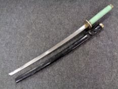 A reproduction Japanese katana in lacquered scabbard
