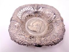 A pierced silver dish inset with a medallion commemorating Queen Victorias Golden Jubilee