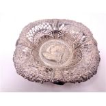 A pierced silver dish inset with a medallion commemorating Queen Victorias Golden Jubilee