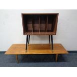 A mid 20th century teak record cabinet on raised legs together with a further coffee table
