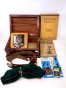 A box containing Boy Scouts ephemera including books, plaque, leather belt,