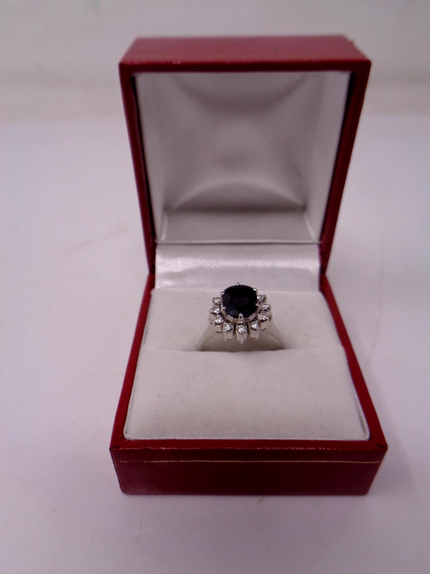 A white gold sapphire and diamond cluster ring