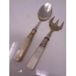 A mother of pearl handled spoon and fork