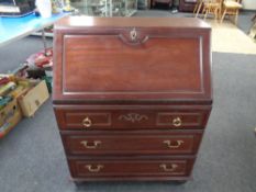 A Rossmore bureau fitted with three drawers