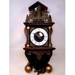 A decorative Dutch wall clock with brass pear drop weights