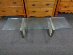 A contemporary refectory glass topped coffee table