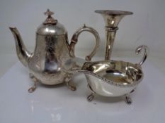 A small silver plated teapot, with a sauce boat and flower holder.