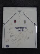 A framed Durham County Cricket Club t-shirt bearing various signatures