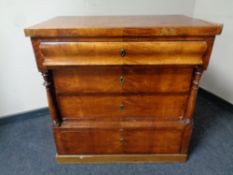 A 19th century Scandinavian satinwood four drawer chest with pillar column supports