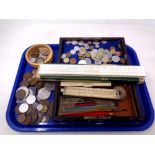 A tray of British and European coins, rulers,