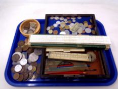 A tray of British and European coins, rulers,