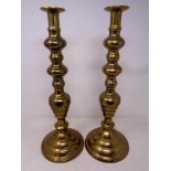 A pair of 19th century brass candlesticks, height 42 cm.