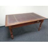 A late Victorian library table with tooled leather inset panel