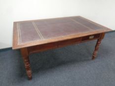A late Victorian library table with tooled leather inset panel