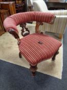A Victorian low backed chair upholstered in red striped fabric