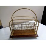 An antique mahogany and brass magazine rack on ball feet