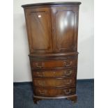 A mahogany bow-fronted drinks cabinet fitted four drawers