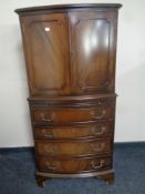 A mahogany bow-fronted drinks cabinet fitted four drawers