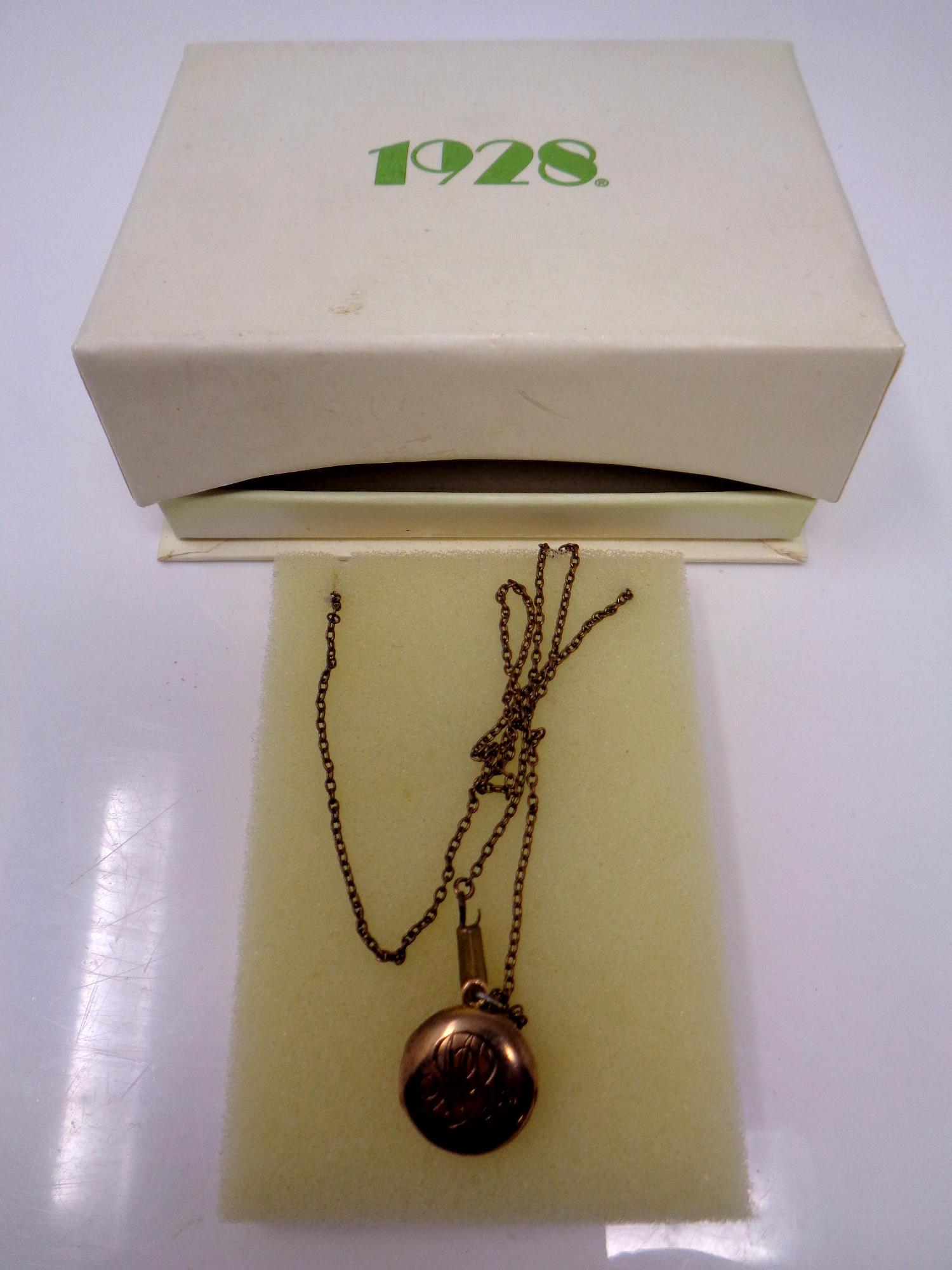 A late 19th century 9ct gold locket, with small round old cut diamond to centre,