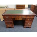 A mahogany twin pedestal writing desk, fitted nine drawers,