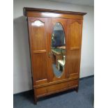 An Edwardian inlaid mahogany mirror door wardrobe