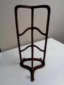 An antique cast iron wall mounted saddle rack