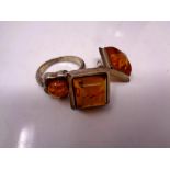 A silver amber ring and earrings