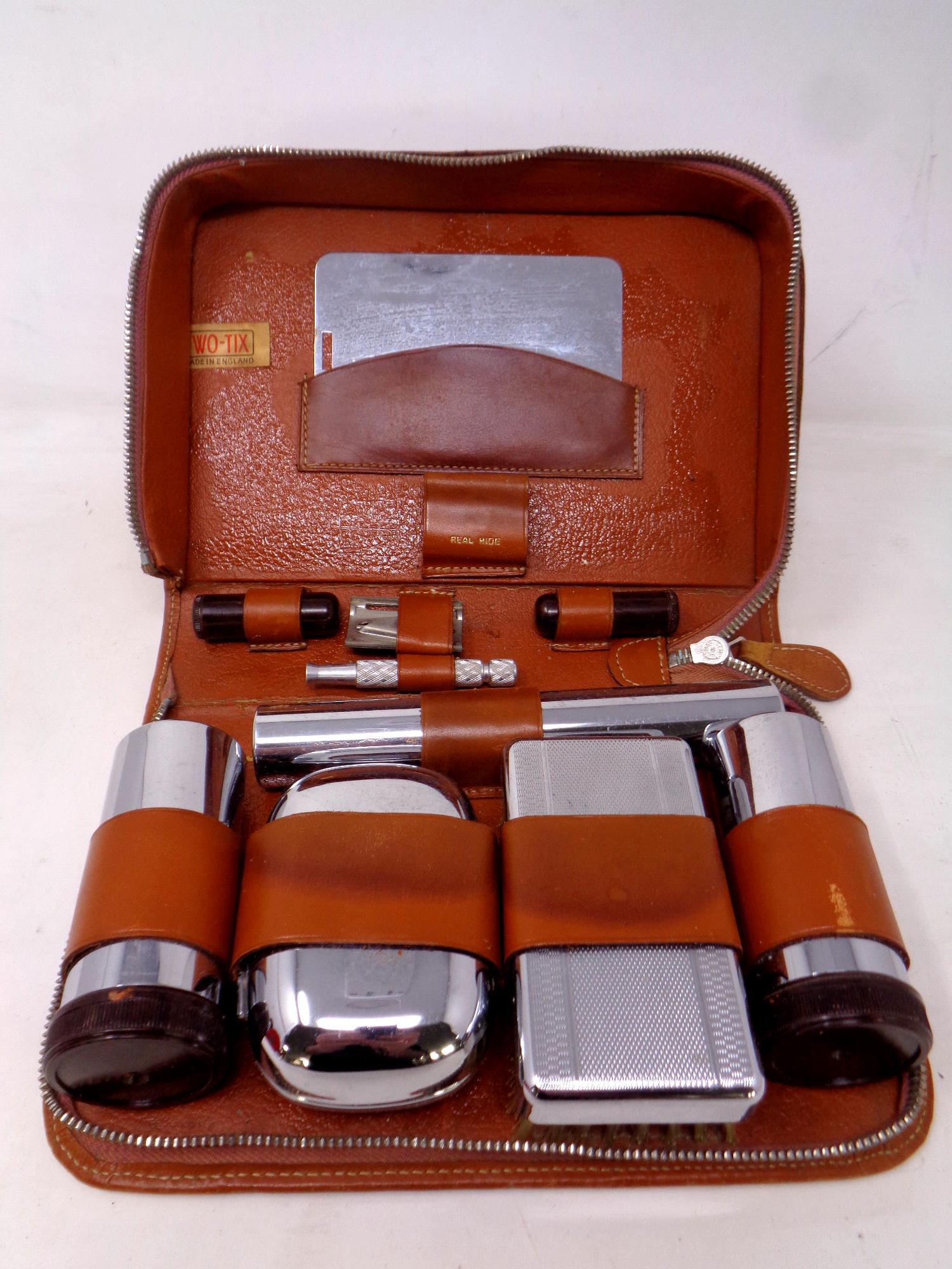 A gent's vanity set in leather case