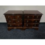 A pair of reproduction serpentine front bedside chests