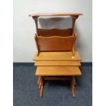 A teak nest of three tables and a magazine rack